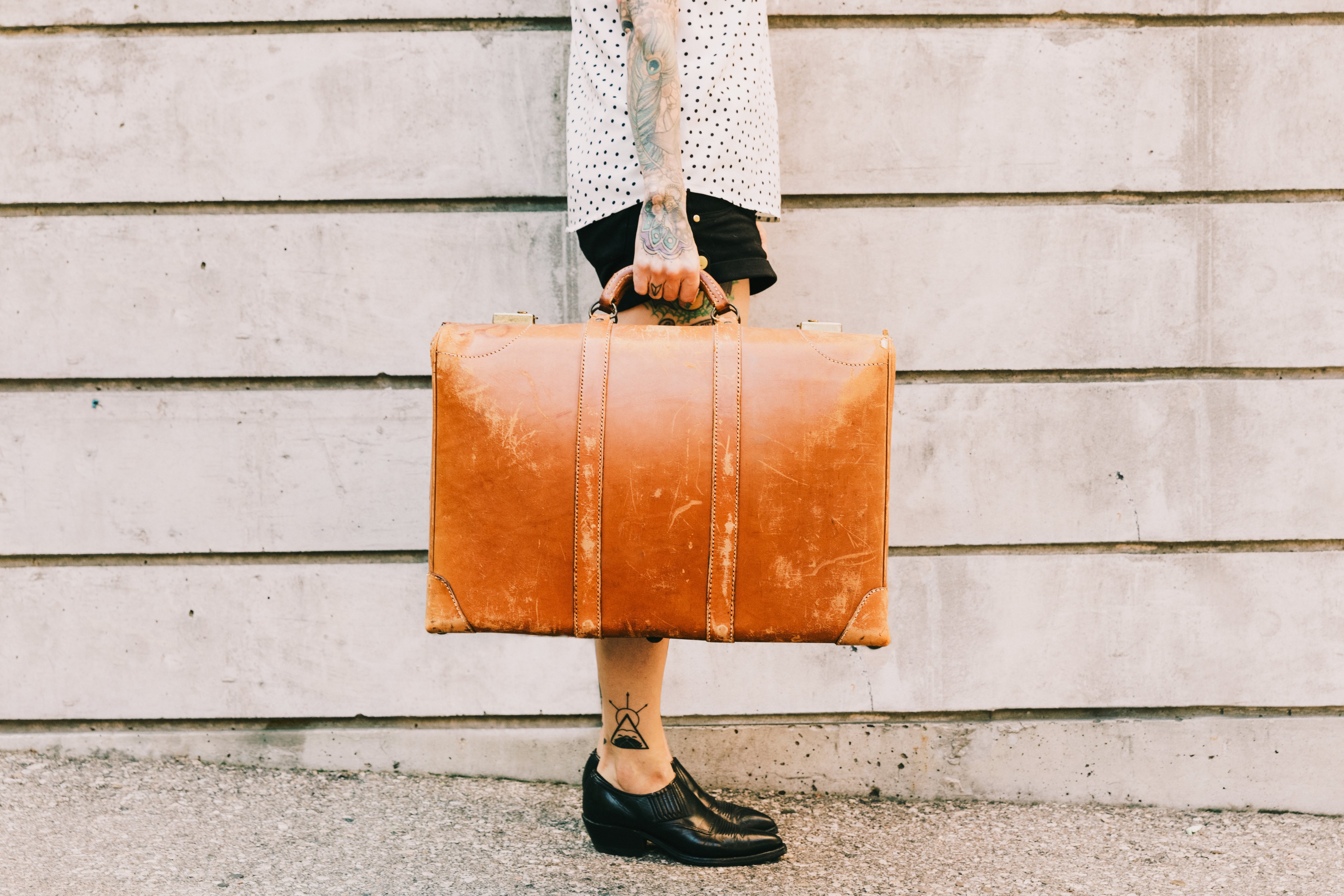 woman-holds-vintage-suitcase